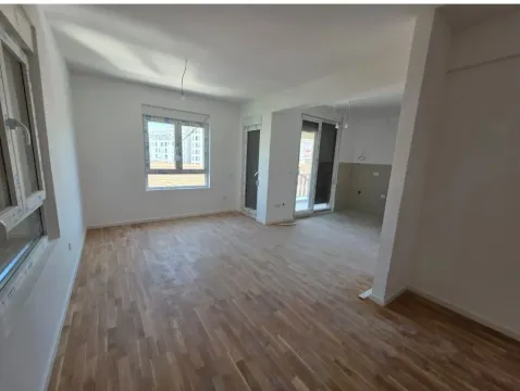 Empty living room with wooden flooring and white walls. - image 3