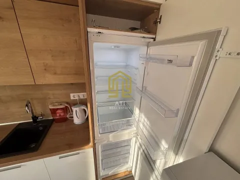 Modern kitchen with a built-in refrigerator and wooden elements. - image 15