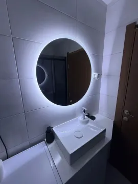 Modern bathroom with a sink and a round illuminated mirror. - image 6