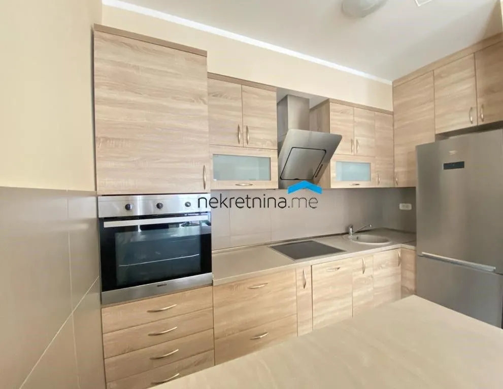 Modern kitchen with wooden cabinets and built-in appliances.
