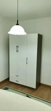 White three-door wardrobe with drawers in a bedroom. - image 9