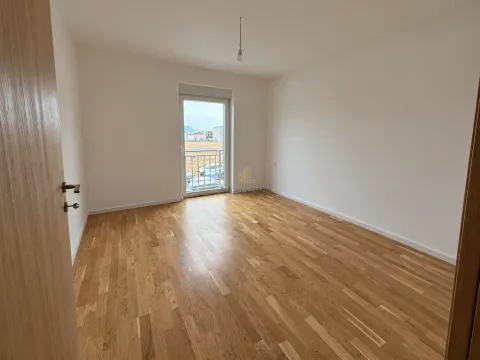 Empty room with hardwood flooring and balcony doors. - image 4