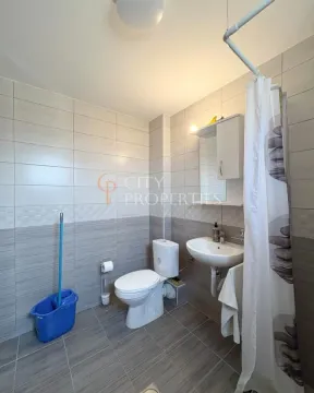 Bathroom equipped with sanitary ware and grey and white tiles. - image 6