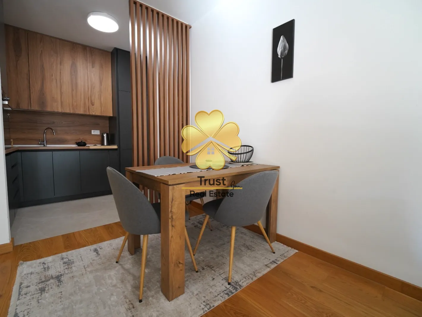 Modern kitchen with a dining area and a wooden partition screen.