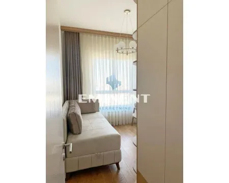 Living room with a sofa and a window with light curtains. - image 13