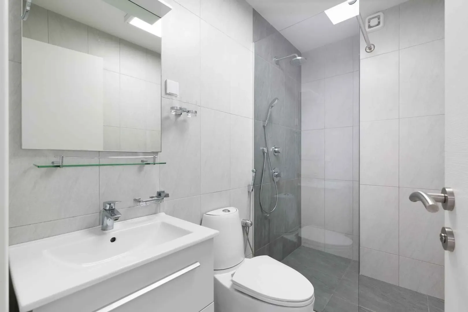 Modernly equipped bathroom with a walk-in shower and sink.