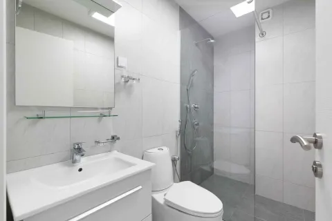 Modernly equipped bathroom with a walk-in shower and sink. - image 31