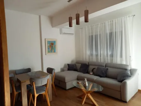 Living room with sofa and dining area. - image 3