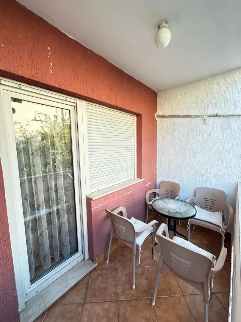 Natkriveni balkon sa garniturom za sjedenje i izlazom u stan.
