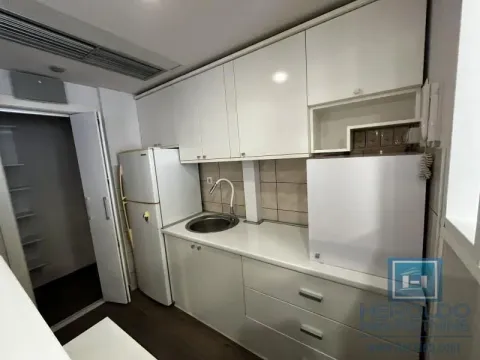 Small white kitchen with a refrigerator and sink. - image 9