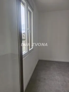 Prazna prostorija sa prozorom i sivim podnim pločicama. - image 6