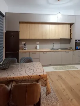 Modern kitchen with built-in cabinetry and an extension dining table. - image 2