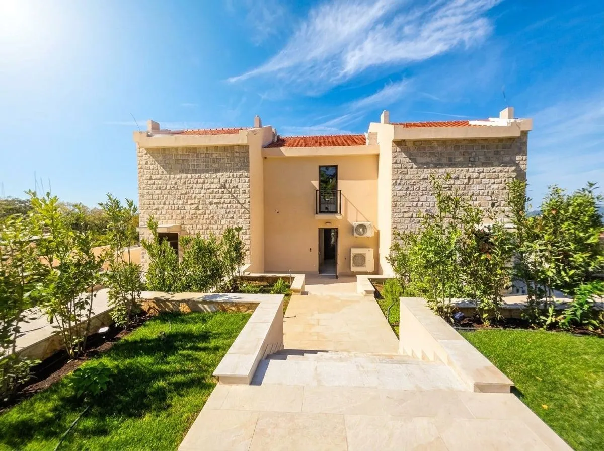 View of the house facade with a landscaped yard and pathway.
