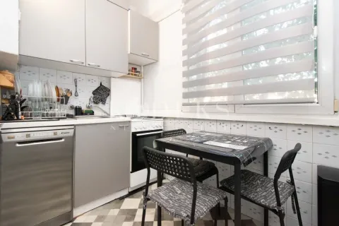 Smaller kitchen with a dining table and chairs by the window. - image 3