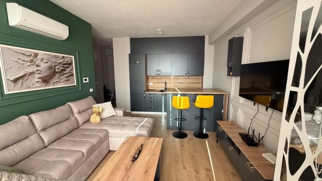 Living room connected with the kitchen and dining area in a modern apartment.