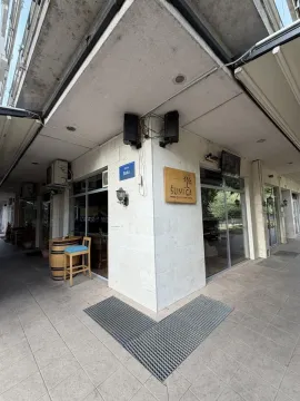 Exterior view of the commercial space with a sign and sidewalk in front. - image 13