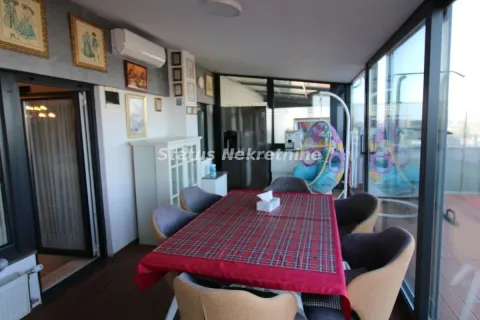 Enclosed terrace with a dining table and chairs. - image 16
