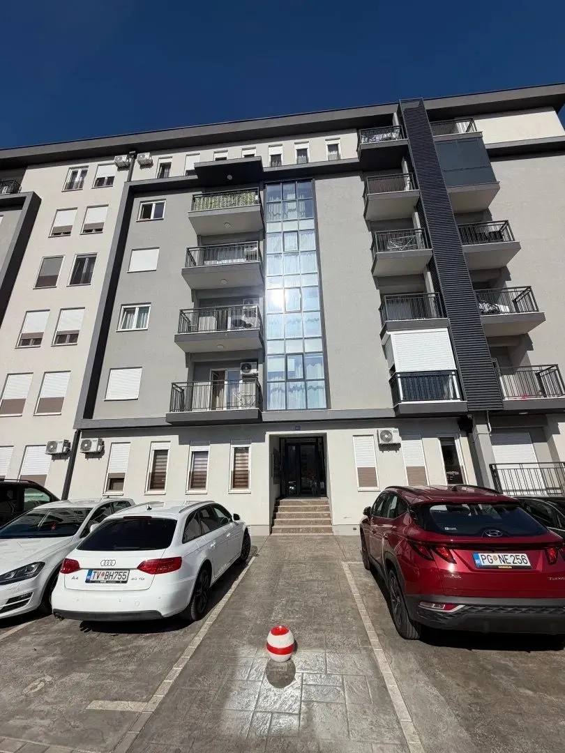 Exterior view of an apartment building with parking.
