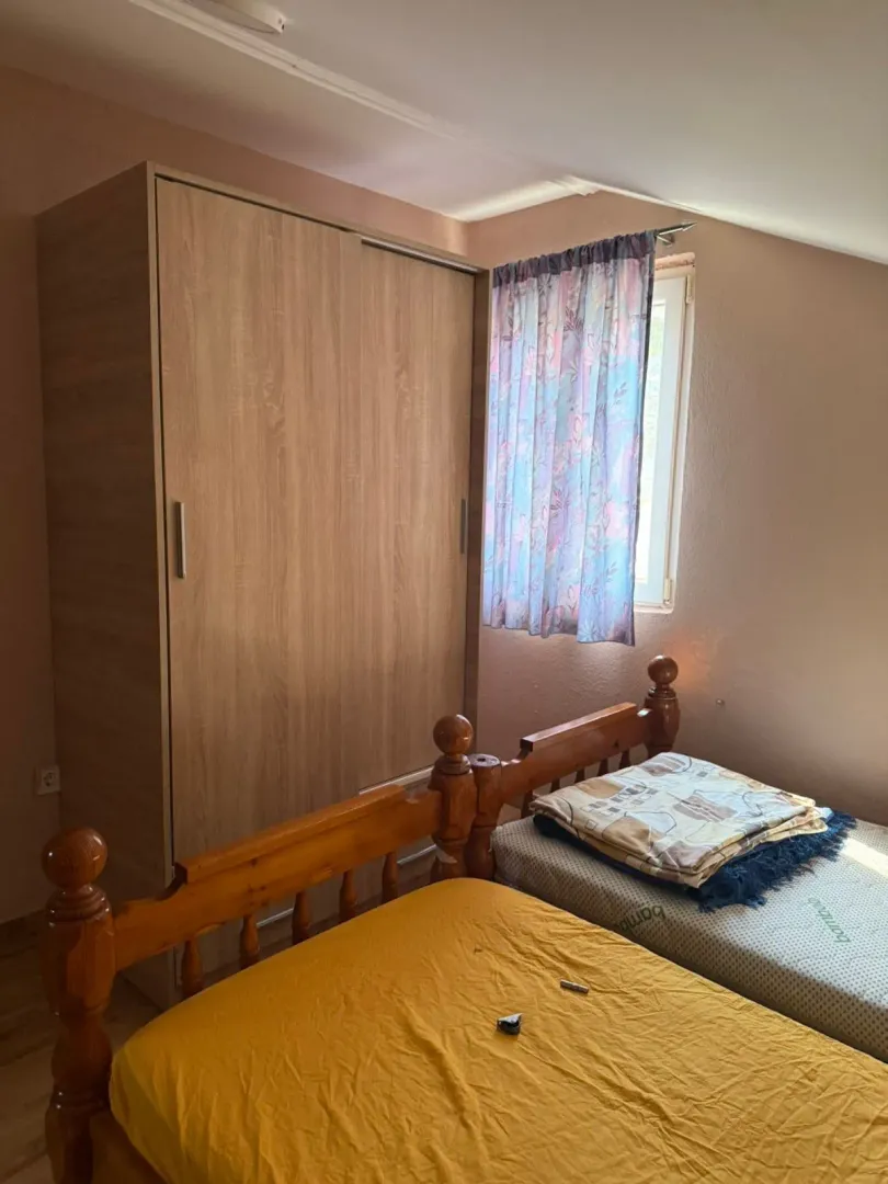 Bedroom with wooden beds and a wardrobe.