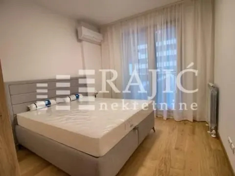 Bedroom with a double bed, air conditioning, and a window with curtains. - image 8