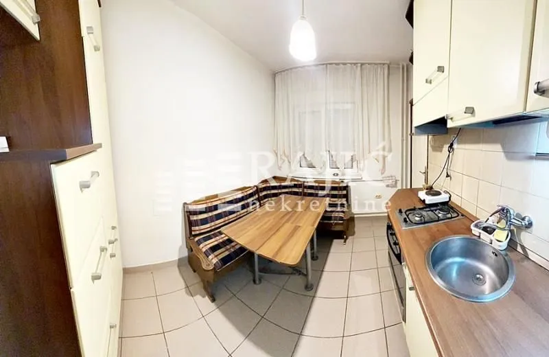 Small kitchen with a dining table and corner bench.