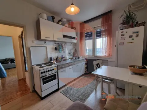 Small kitchen with a dining table and a stove. - image 7