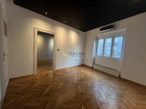 Empty room with wooden parquet flooring, white walls and a black ceiling. - image 10