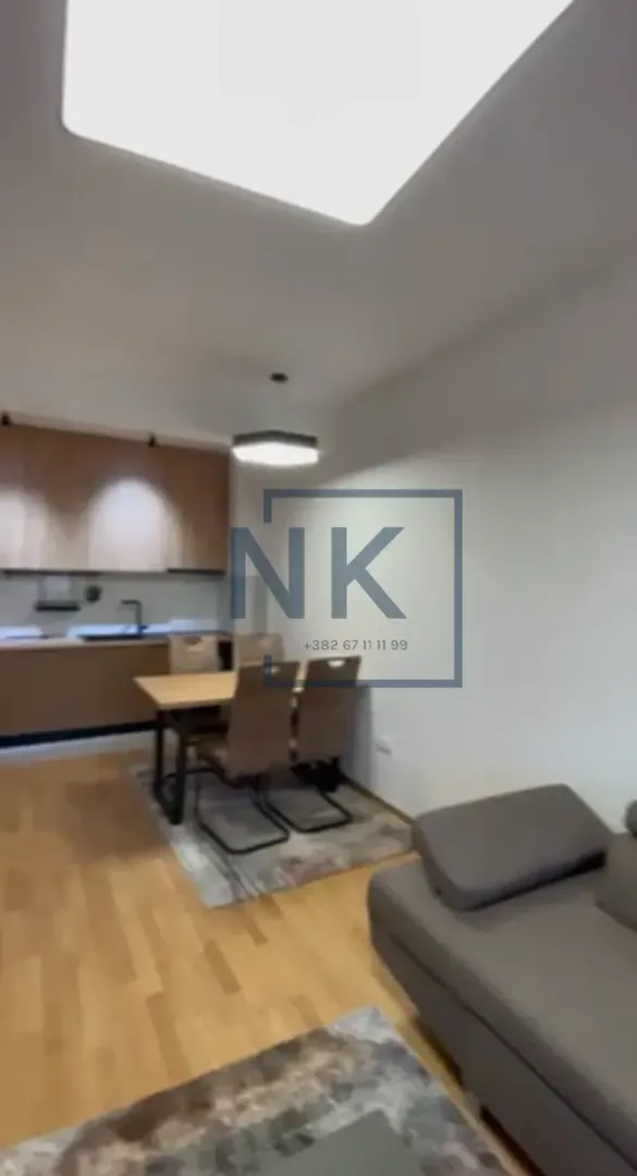 Living room with dining area and kitchen in the background.