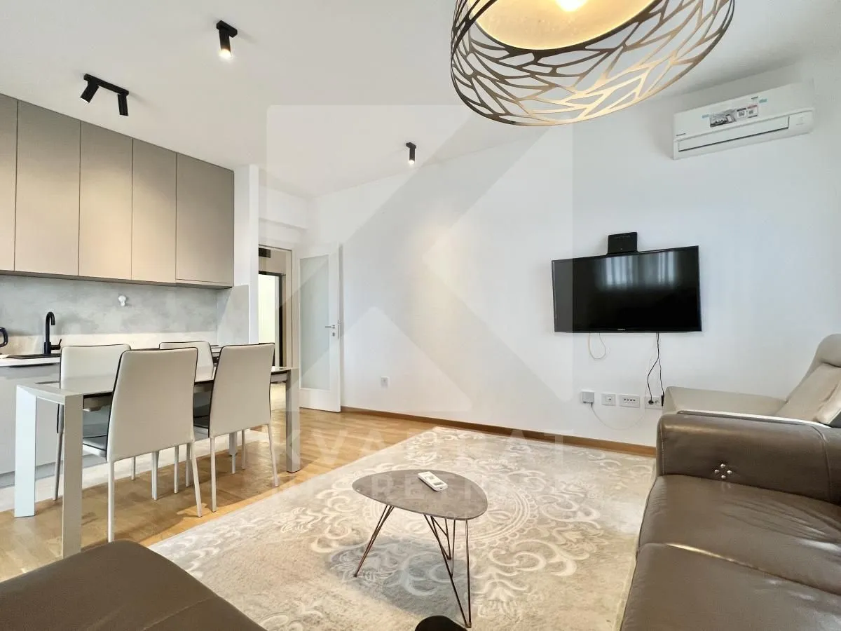 Living room with dining area and kitchen in an open-plan layout.