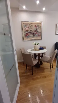 Dining area with a round table and four chairs. - image 3