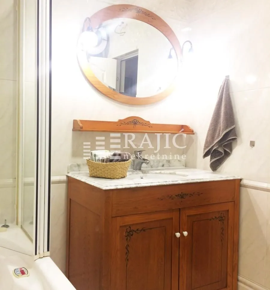 Bathroom with wooden vanity and mirror.