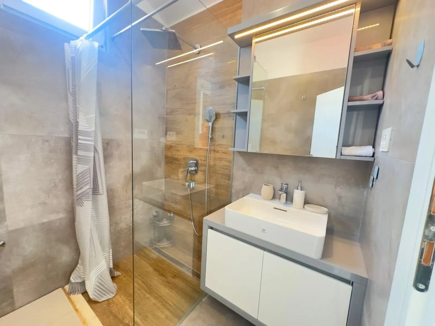 Modern bathroom with a walk-in shower and vanity.
