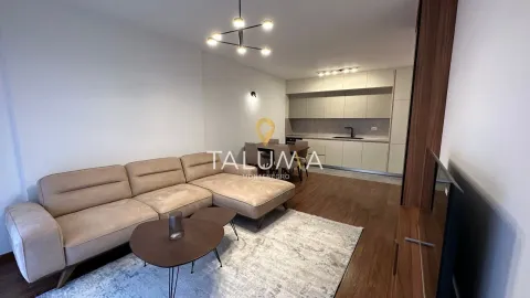 Living room with sofa and dining area connected to the kitchen. - image 2