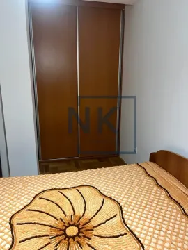 Bedroom with a bed and a wooden wardrobe. - image 6