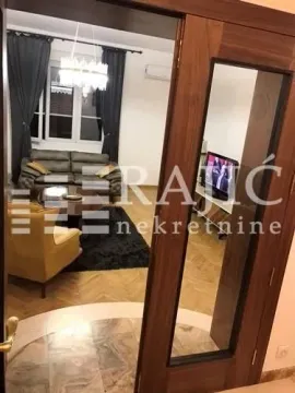 Pogled iz hodnika na dnevni boravak sa garniturom i parketom. - image 4