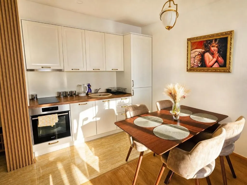 Kitchen with a dining area and white cabinetry.