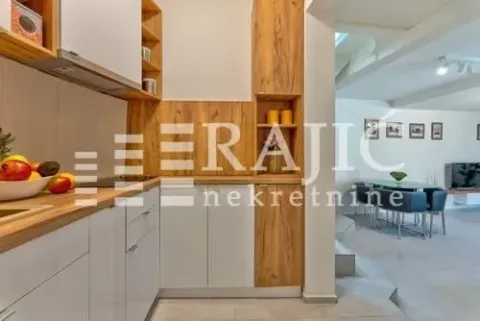Modern kitchen with white and wooden elements, overlooking the dining area. - image 9