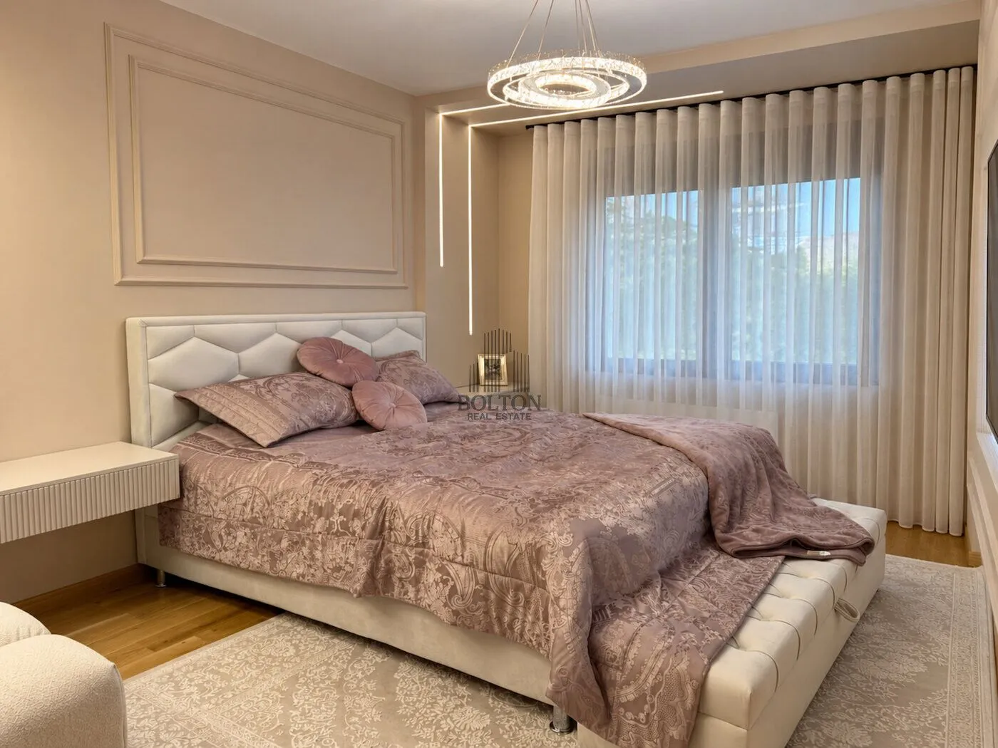 Modern bedroom with a double bed and elegant lighting.