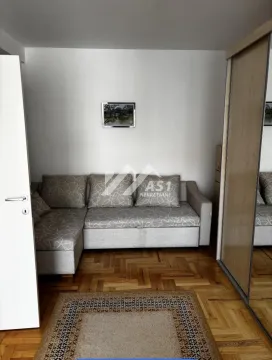 Small living room with a corner sofa and a large mirrored wardrobe. - image 5