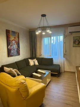 Living room with a sectional sofa, an armchair, and a coffee table. - image 2