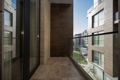 Modern balcony with a glass railing and a view of the neighborhood. - image 2