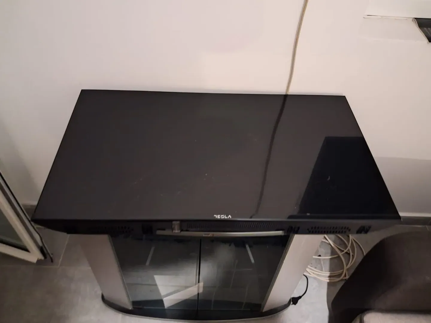 Top-down view of a television on a stand in a room.