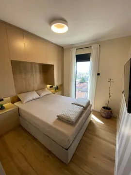 Modern bedroom with a double bed, fitted wardrobes, and a window view. - image 12
