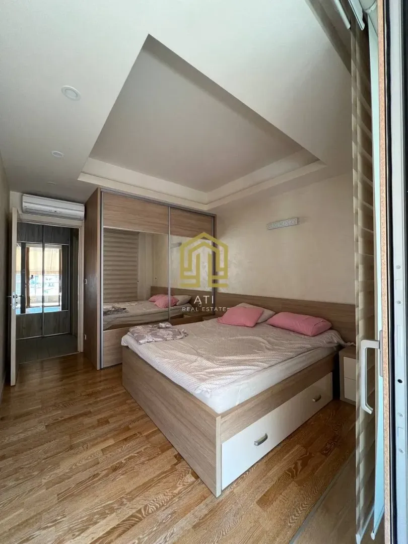 Furnished bedroom with a double bed and built-in wardrobe.
