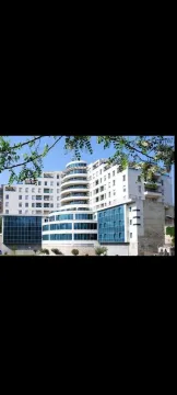 Exterior view of a modern residential building with a glass facade. - image 2