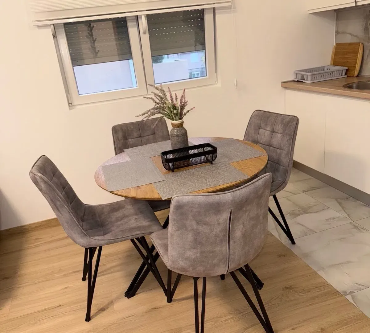 Dining table with four chairs as part of the kitchen.