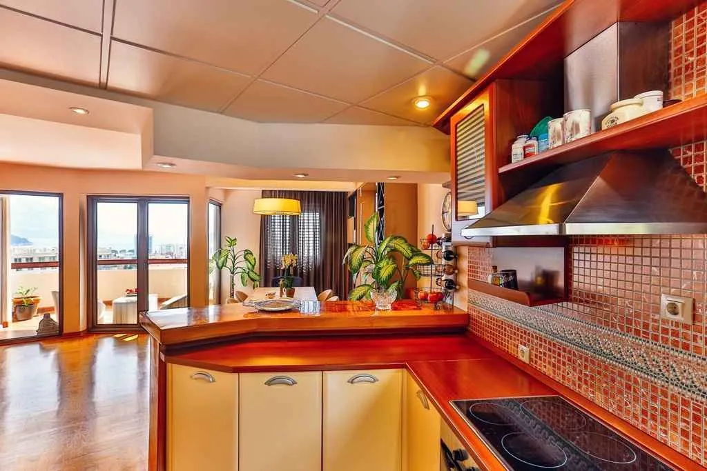 Bright kitchen with wooden countertops connected to the dining area.