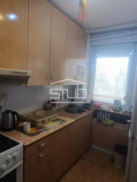 Small kitchen with wooden cabinetry and a window. - image 6