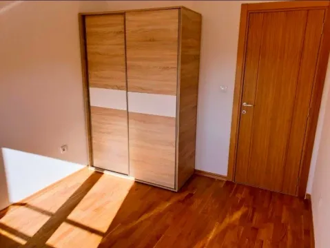 Room with a wooden wardrobe, parquet flooring, and an interior door. - image 8