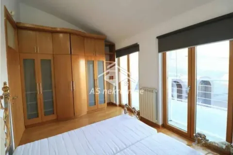 Bedroom with a double bed and a large wooden wardrobe. - image 12